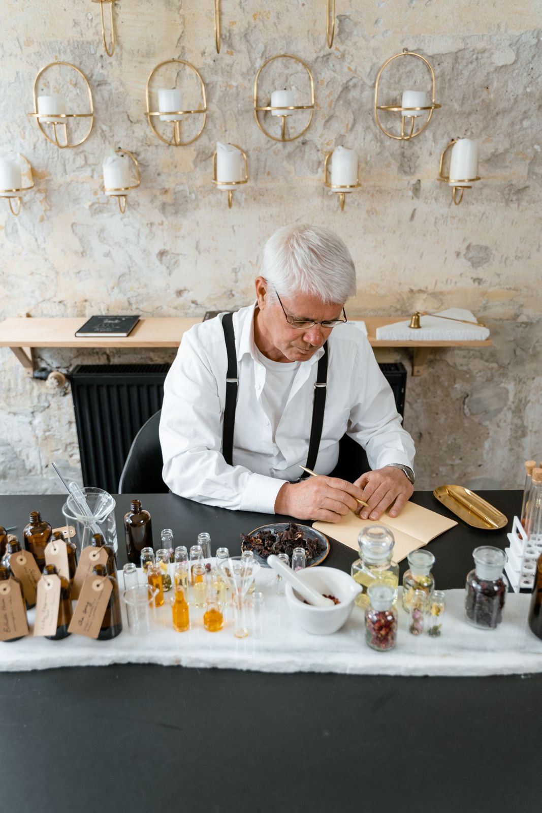 A perfumer blending a fragrance at the workbench